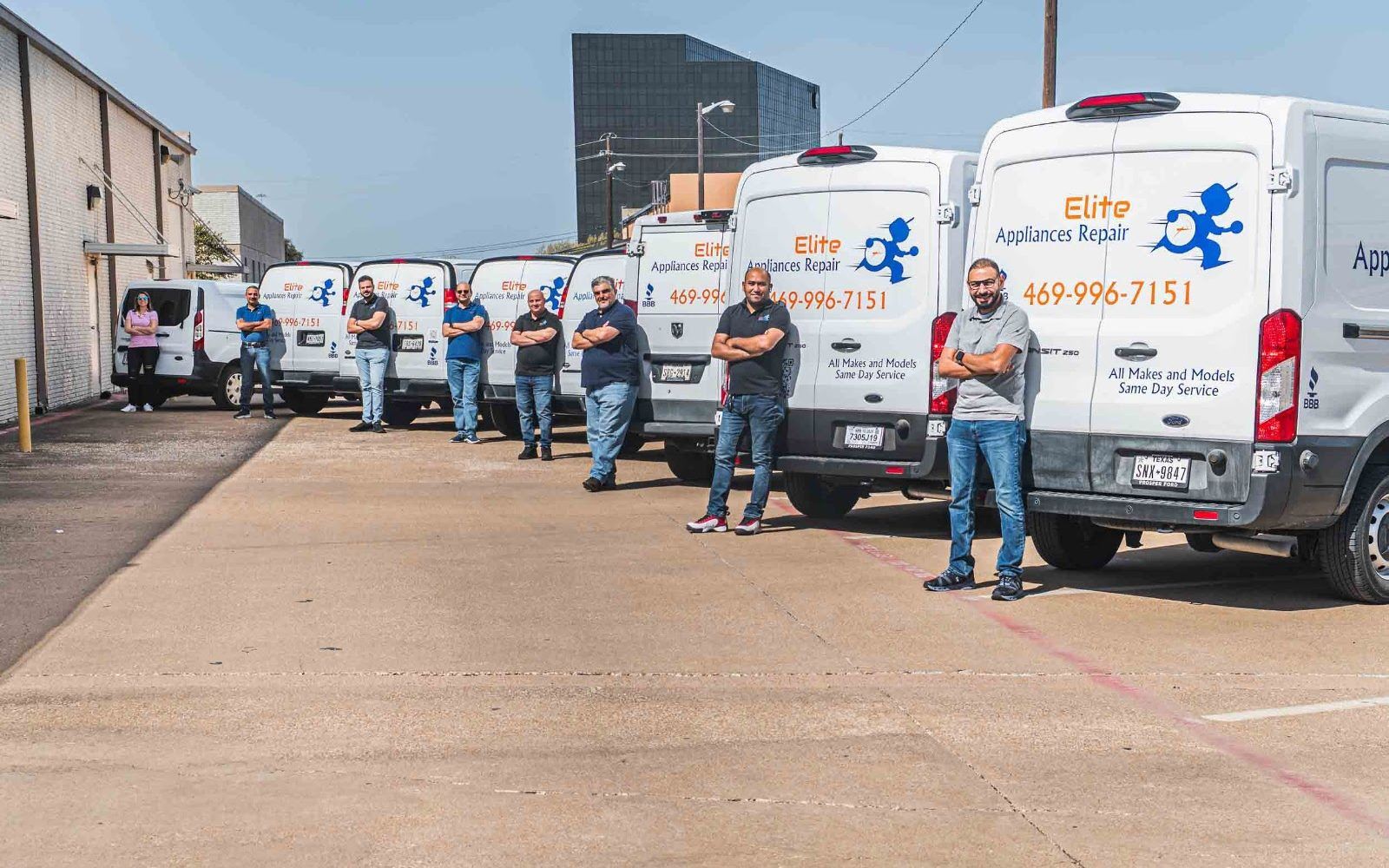 Technician loading parts into an Elite Appliances Repairs service van for appliance repair Dallas